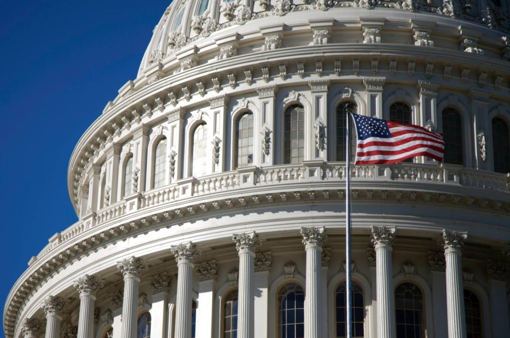 Picture of US flag flying in front of US Capitol